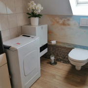 modern attic bathroom with beach wallpaper